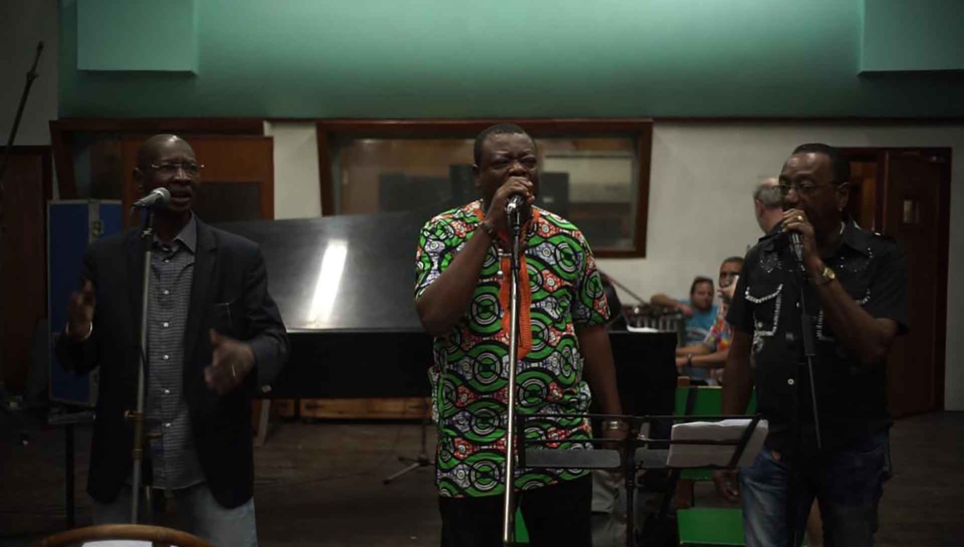 Trois chanteurs maliens chantent dans une pièce sombre. Extrait du film Africa Mia de Richard Minier et Édouard Salier.