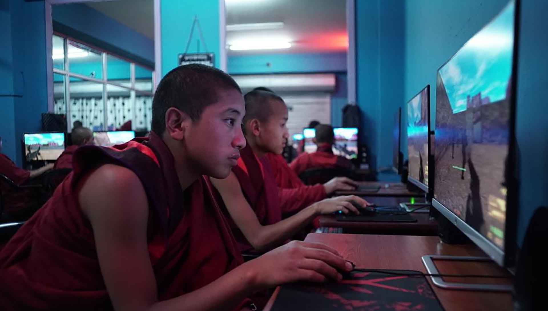 Des moines jouent à des jeux vidéos. Extrait du film Sing Me a Song de Thomas Balmès.